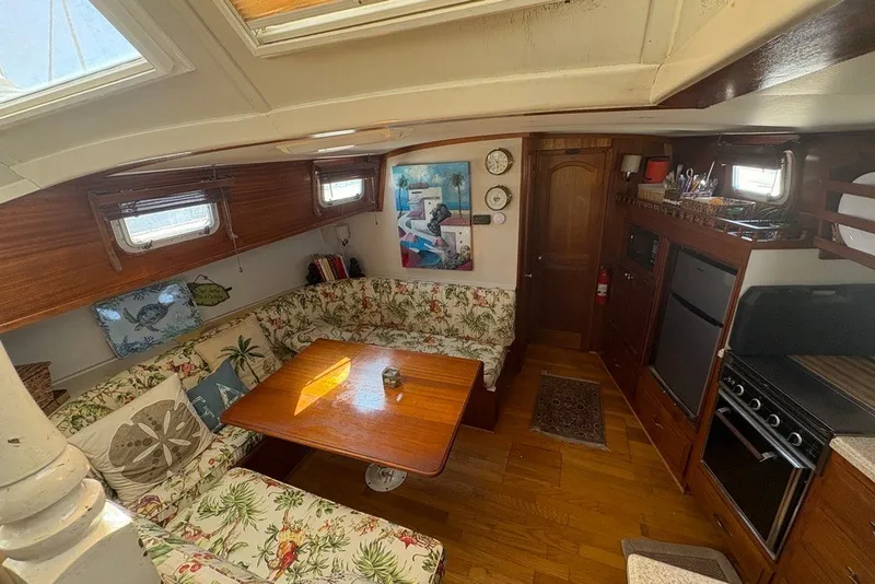 Slide: The Image of Interior of 1975 Gulfstar 43 Trawler with cozy dining area and kitchen amenities. - 21