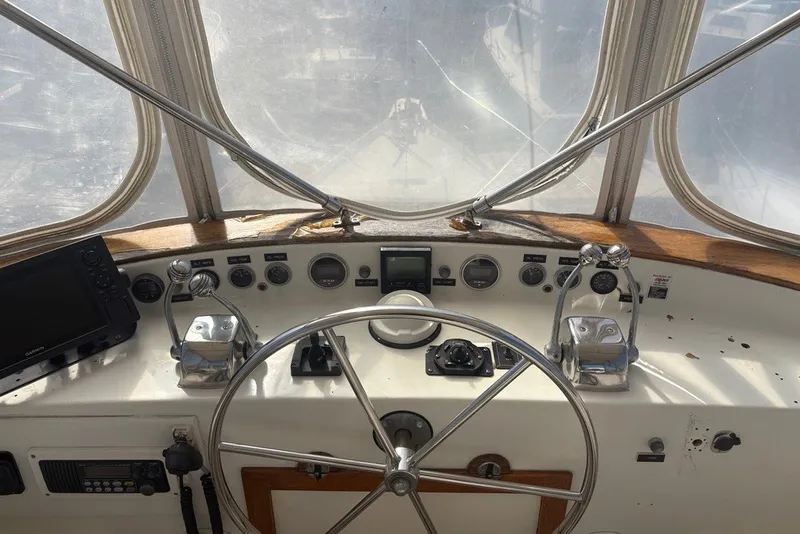 Slide: The Image of 1975 Gulfstar 43 Trawler helm with steering wheel, controls, and navigation equipment. - 71