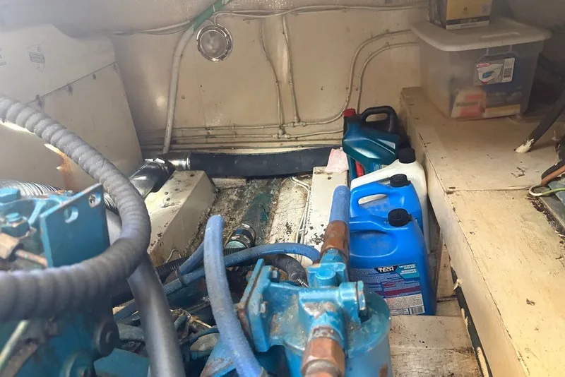 Slide: The Image of Engine room of a 1975 Gulfstar 43 Trawler with maintenance supplies and equipment. - 107