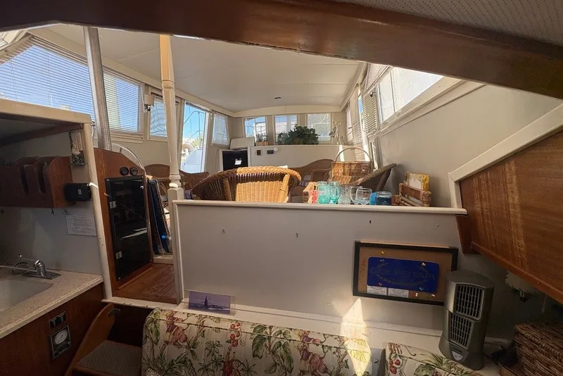 Slide: The Image of Interior of 1975 Gulfstar 43 Trawler with wicker seating and floral upholstery. - 44