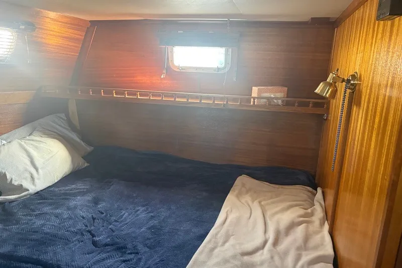 Slide: The Image of Cozy cabin interior of 1975 Gulfstar 43 Trawler with wooden walls and bedding. - 64