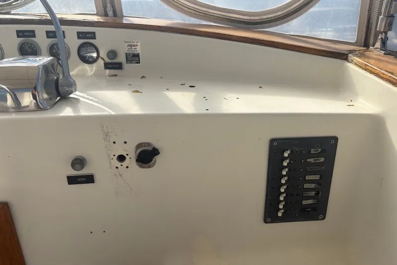 Slide: The Image of 1975 Gulfstar 43 Trawler helm with gauges, controls, and switch panel. - 73