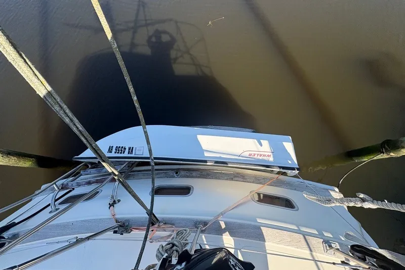 Slide: The Image of Overhead view of 1975 Gulfstar 43 Trawler docked, showing deck and water reflection. - 84