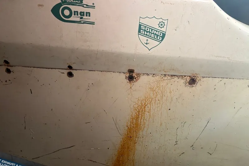 Slide: The Image of 1975 Gulfstar 43 Trawler hull with rust and Onan, Sound Shield logos. - 110