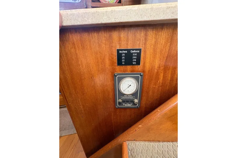 Slide: The Image of Wooden panel with fuel gauge and capacity chart on 1975 Gulfstar 43 Trawler. - 45