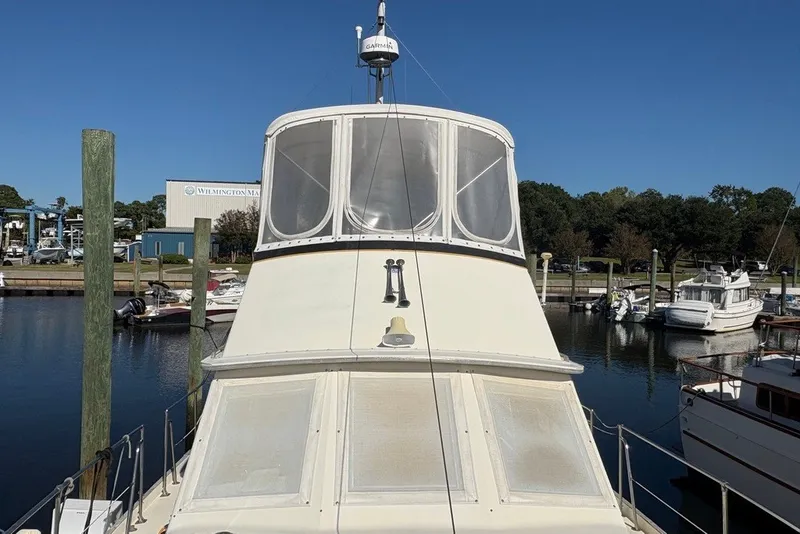 Slide: The Image of 1975 Gulfstar 43 Trawler docked at marina under clear blue sky. - 93