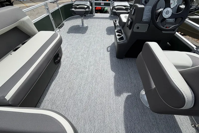 Slide: The Image of 2027 Sun Tracker Bass Buggy 16 XL Select interior with gray seating and steering console. - 15