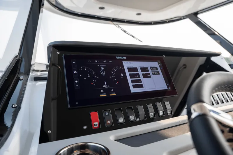 Slide: The Image of The image shows the dashboard of a Cruisers Yachts 38 VTR with modern instruments and switches. - 14