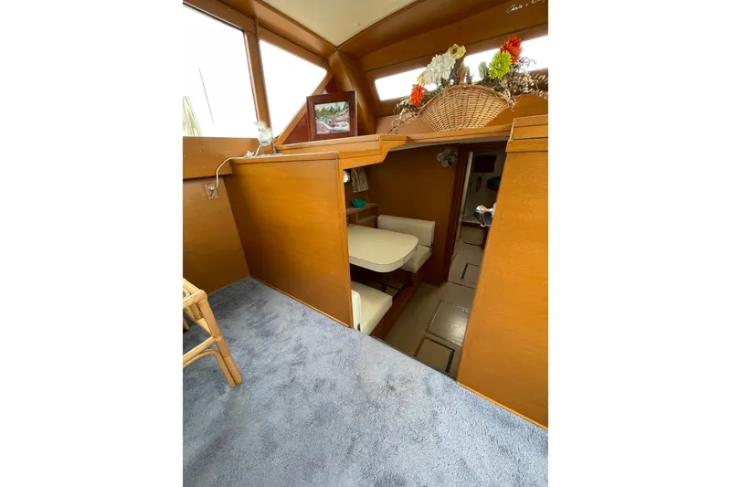 Slide: The Image of Interior of 1962 Chris-Craft 55 Commander yacht with wooden paneling and cozy seating area. - 24