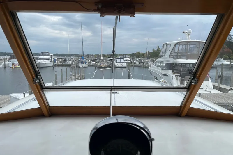 Slide: The Image of View from 1962 Chris-Craft 55 Commander yacht cockpit, overlooking marina with docked boats. - 36