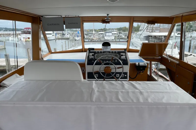 Slide: The Image of 1962 Chris-Craft 55 Commander helm with Garmin navigation, docked at marina. - 35