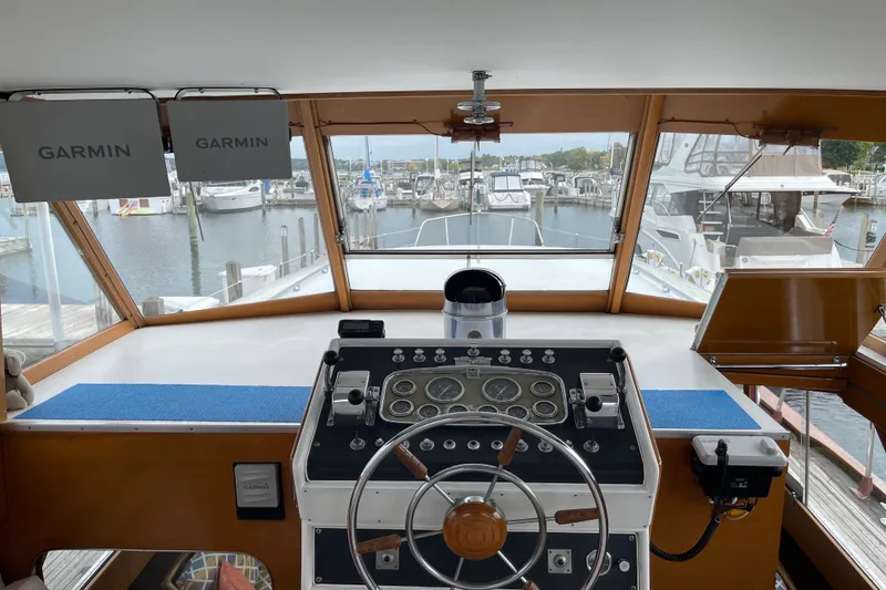 Slide: The Image of 1962 Chris-Craft 55 Commander helm with Garmin navigation, docked at marina. - 31