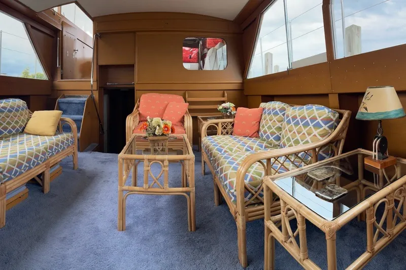 Slide: The Image of Luxurious interior of 1962 Chris-Craft 55 Commander with wicker furniture and nautical decor. - 41