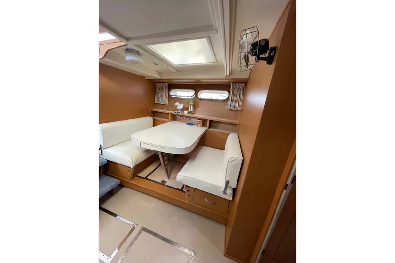 Slide: The Image of Interior of 1962 Chris-Craft 55 Commander with cozy dining area and white seating. - 26