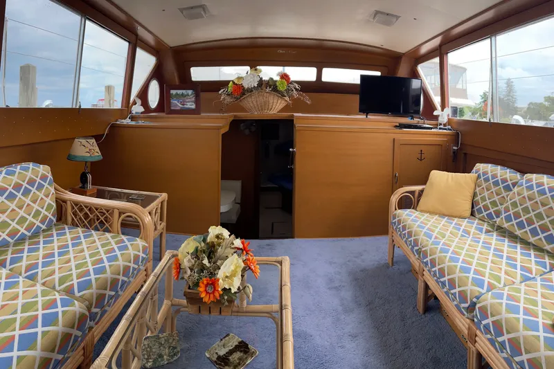 Slide: The Image of Interior of 1962 Chris-Craft 55 Commander yacht with cozy seating and floral decor. - 27