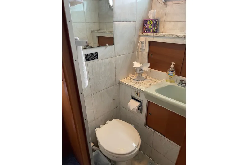 Slide: The Image of Bathroom interior of 1962 Chris-Craft 55 Commander yacht, featuring toilet and sink. - 30