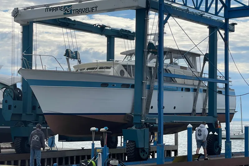 Slide: The Image of 1962 Chris-Craft 55 Commander yacht in a boat lift at a marina. - 15