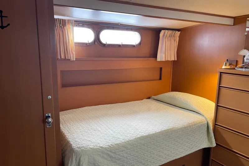 Slide: The Image of Cozy cabin interior of 1962 Chris-Craft 55 Commander yacht with bed and porthole windows. - 34
