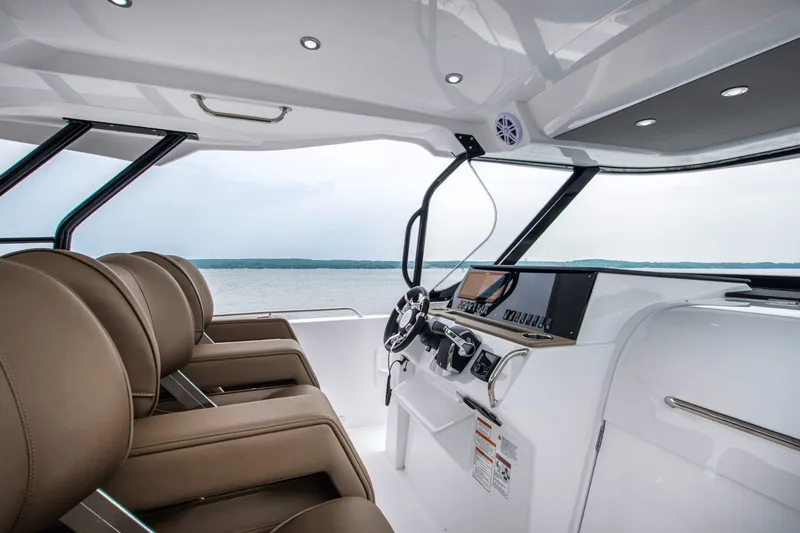 Slide: The Image of The image shows the cockpit of a 2027 Cruisers Yachts 38 VTR EC with modern seating and controls. - 14