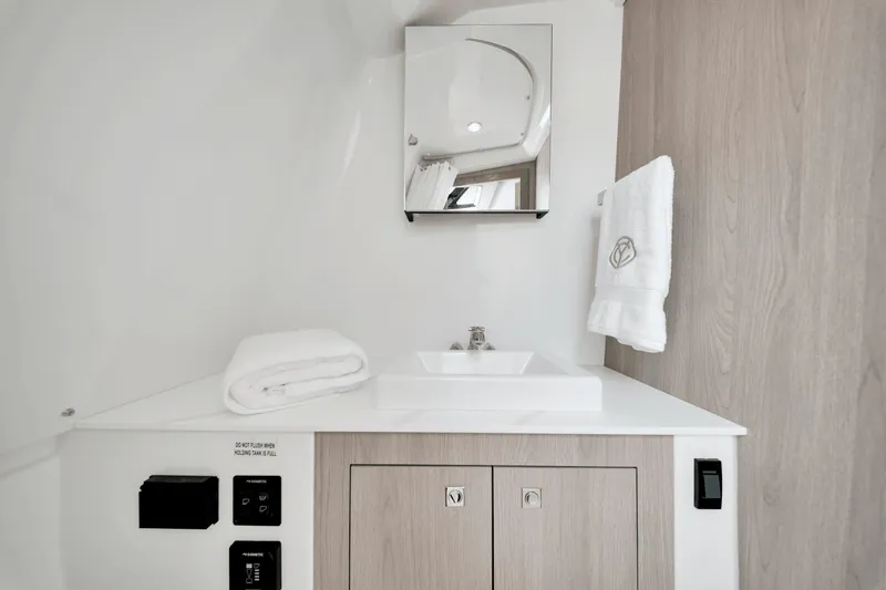 Slide: The Image of Modern bathroom with sink, mirror, and towels in a Cruisers Yachts 38 VTR EC. - 21