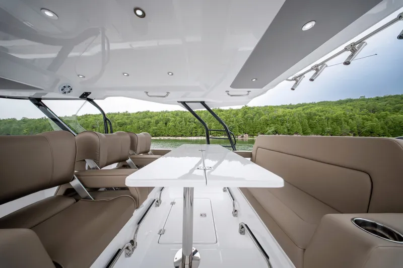 Slide: The Image of The image shows the cockpit of a 2027 Cruisers Yachts 38 VTR EC with sleek seating and a table. - 18