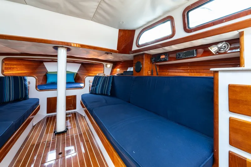 Slide: The Image of Interior of 2009 Morris M36 sailboat with blue seating and wooden accents. - 39