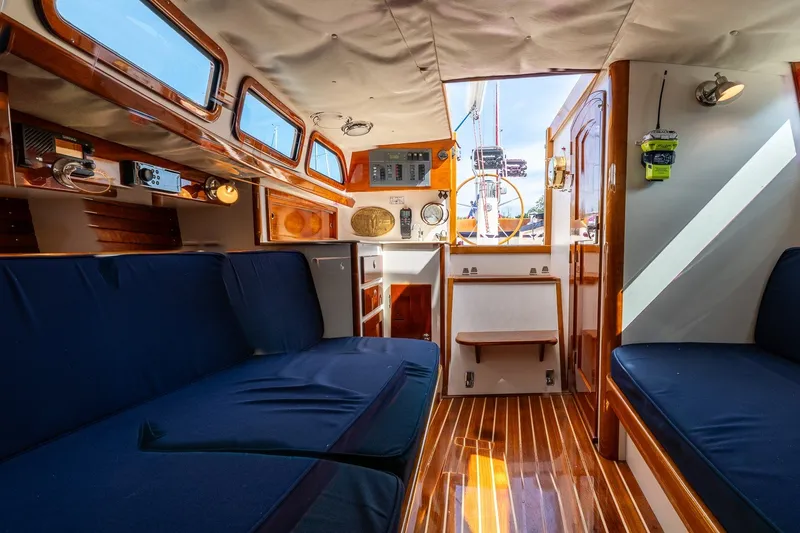 Slide: The Image of Interior of a 2009 Morris M36 sailboat with wooden finishes and blue seating. - 43