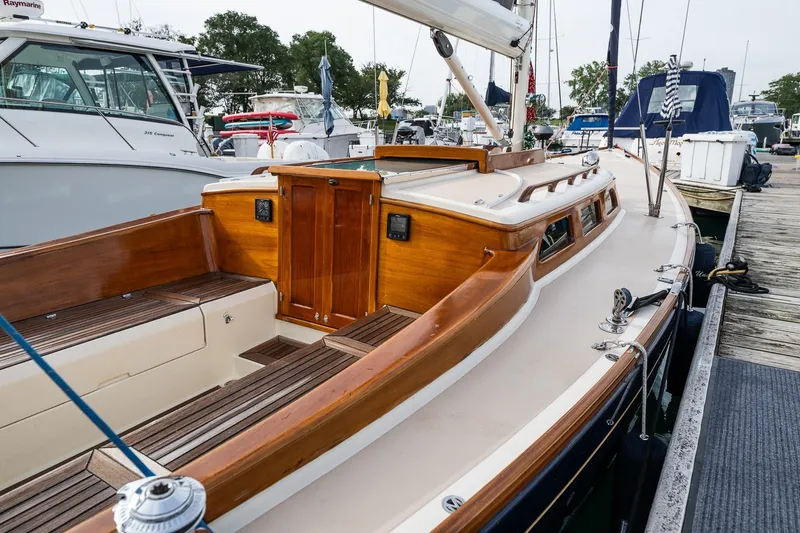 Slide: The Image of 2009 Morris M36 sailboat with wooden deck and cabin, docked at a marina. - 29