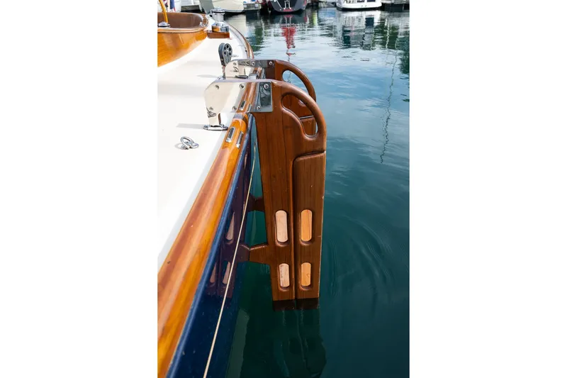 Slide: The Image of Wooden swim ladder on Morris M36 yacht, 2009, docked in calm marina waters. - 22