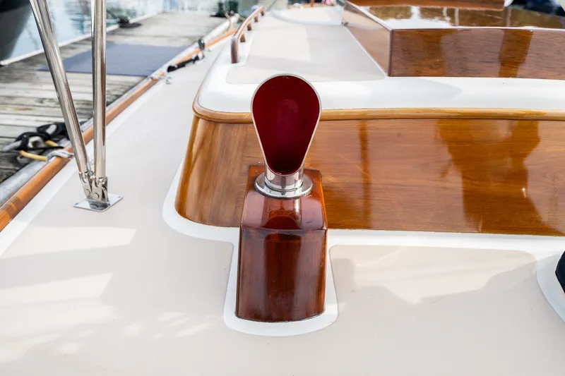 Slide: The Image of Wooden deck detail of a 2009 Morris M36 sailboat, featuring polished wood and chrome accents. - 14
