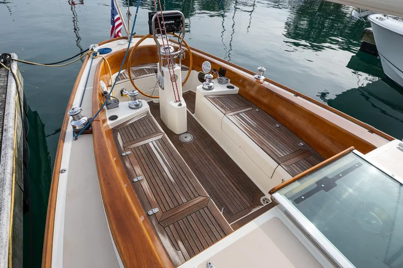 Slide: The Image of Elegant 2009 Morris M36 sailboat with polished wood deck and American flag at marina. - 24