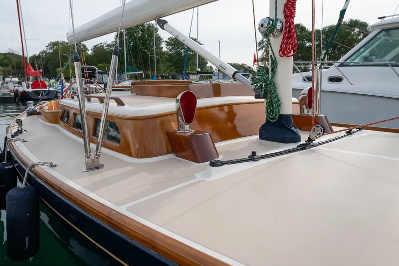 Slide: The Image of 2009 Morris M36 sailboat deck with polished wood and rigging in a marina. - 11