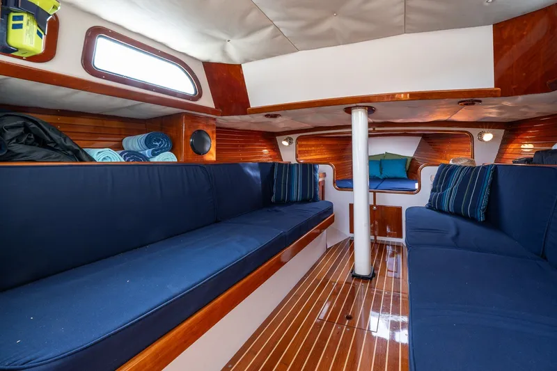 Slide: The Image of Interior of 2009 Morris M36 sailboat with blue seating and wooden accents. - 38