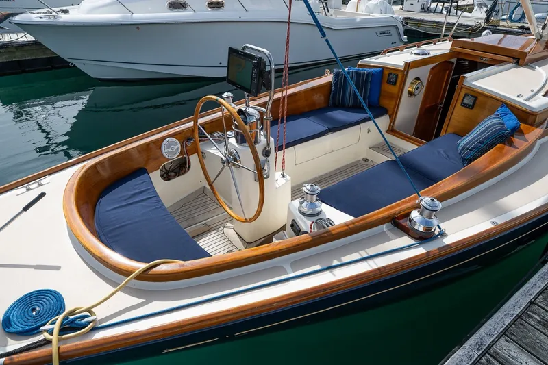Slide: The Image of Luxurious 2009 Morris M36 sailboat with wooden accents and blue seating at a marina. - 28