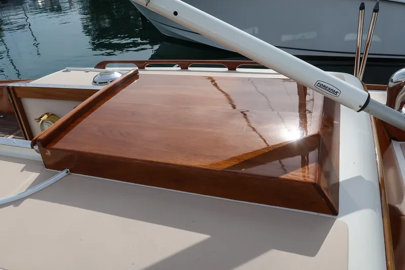 Slide: The Image of Polished wooden deck of a 2009 Morris M36 sailboat, featuring a Forespar tiller. - 12