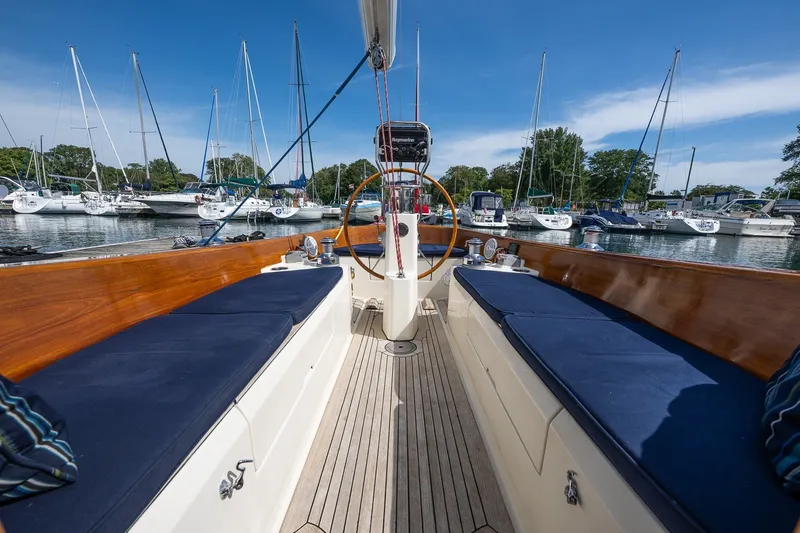 Slide: The Image of Cockpit view of 2009 Morris M36 sailboat docked in a marina with blue cushions. - 34