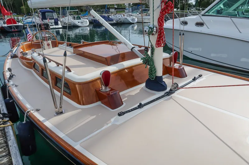 Slide: The Image of Sleek 2009 Morris M36 sailboat docked, showcasing elegant wooden deck and nautical details. - 10