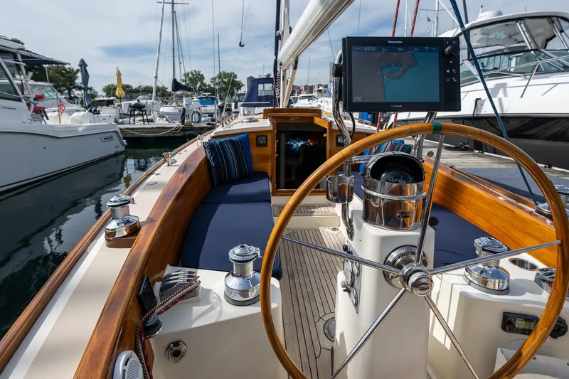 Slide: The Image of 2009 Morris M36 sailboat cockpit with wooden wheel and navigation display at marina. - 32