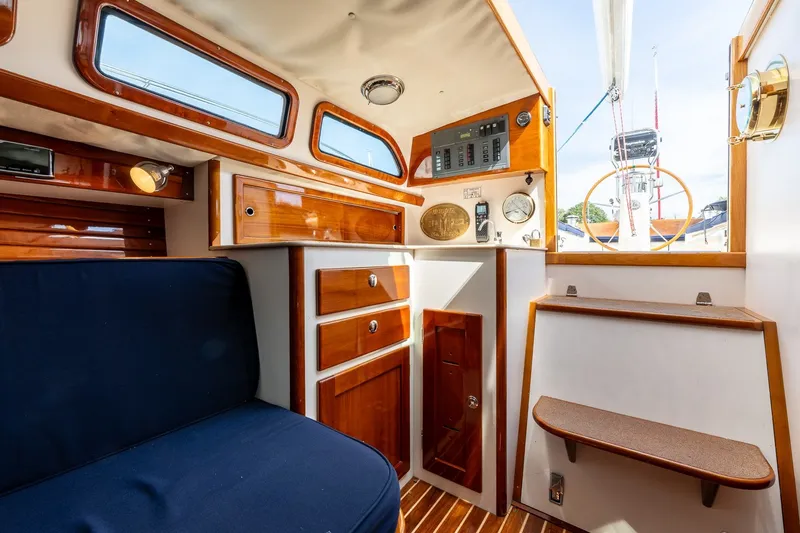 Slide: The Image of Interior of 2009 Morris M36 sailboat with wooden cabinetry and blue seating. - 44