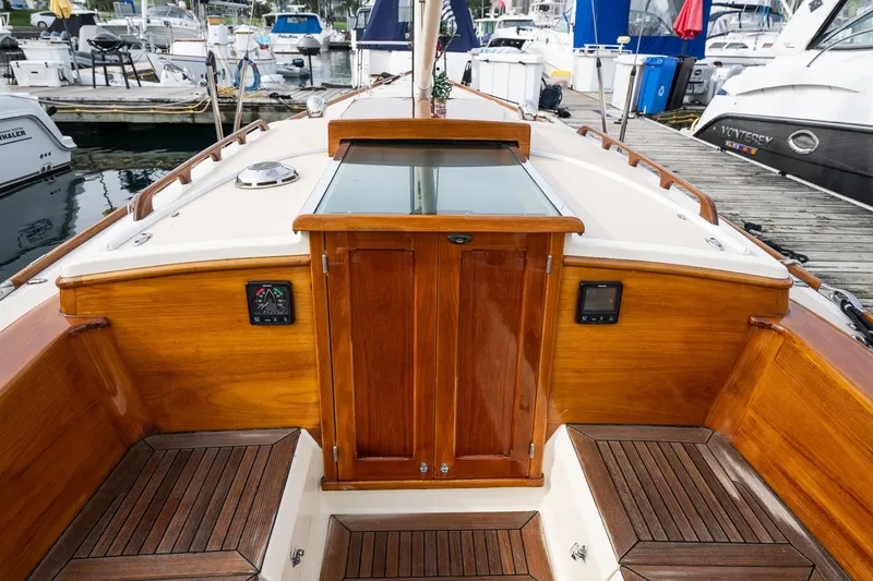 Slide: The Image of 2009 Morris M36 yacht cockpit with wooden finish and marina background. - 36