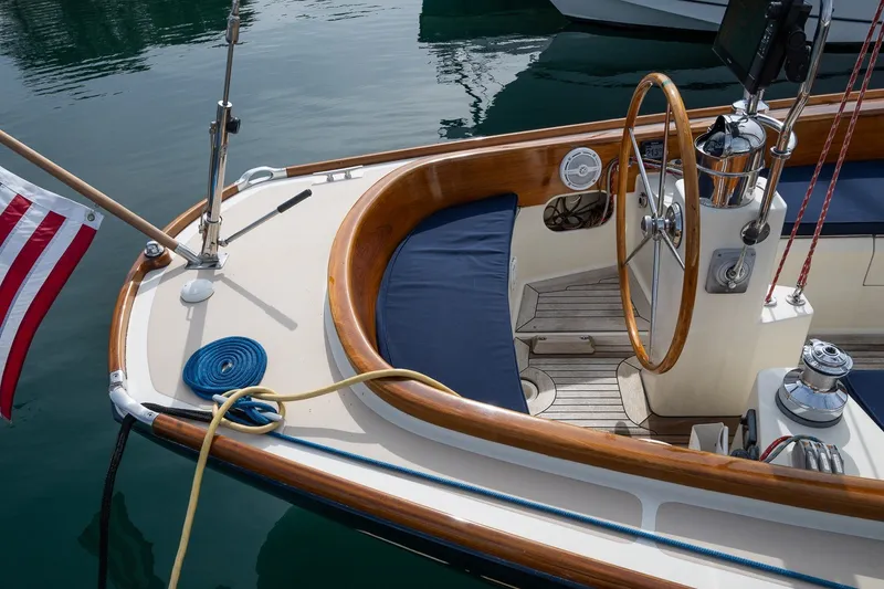 Slide: The Image of 2009 Morris M36 sailboat cockpit with wooden accents and American flag. - 26