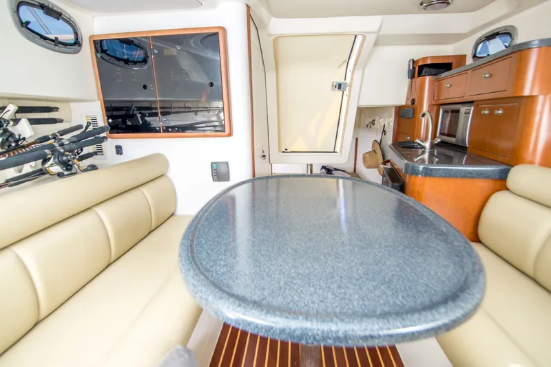 Slide: The Image of Interior of 2005 Boston Whaler 305 Conquest with dining area and kitchenette. - 12