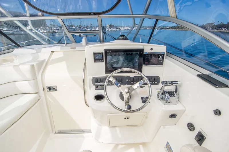 Slide: The Image of Helm of 2005 Boston Whaler 305 Conquest with navigation equipment and steering wheel. - 22