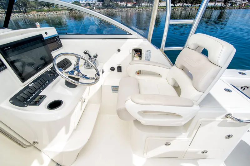 Slide: The Image of Helm of 2005 Boston Whaler 305 Conquest with steering wheel and control panel. - 20
