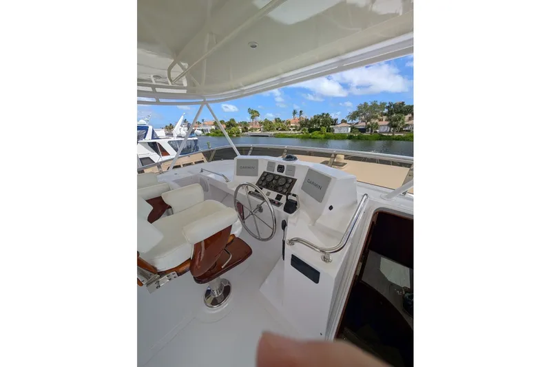 Slide: The Image of Helm of 1998 Offshore Yachts 54 Pilot House with dual seats and navigation equipment. - 15