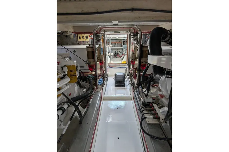 Slide: The Image of Engine room of a 1998 Offshore Yachts 54 Pilot House, showcasing machinery and equipment. - 17