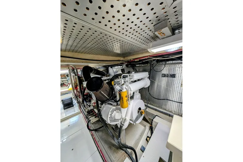Slide: The Image of Engine room of 1998 Offshore Yachts 54 Pilot House, showcasing mechanical components. - 19