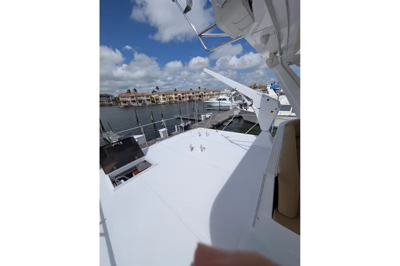 Slide: The Image of 1998 Offshore Yachts 54 Pilot House on a sunny marina day. - 16