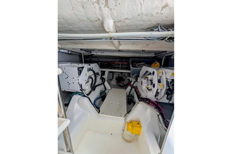 Slide: The Image of Engine room of a 1998 Offshore Yachts 54 Pilot House, showcasing mechanical components. - 20