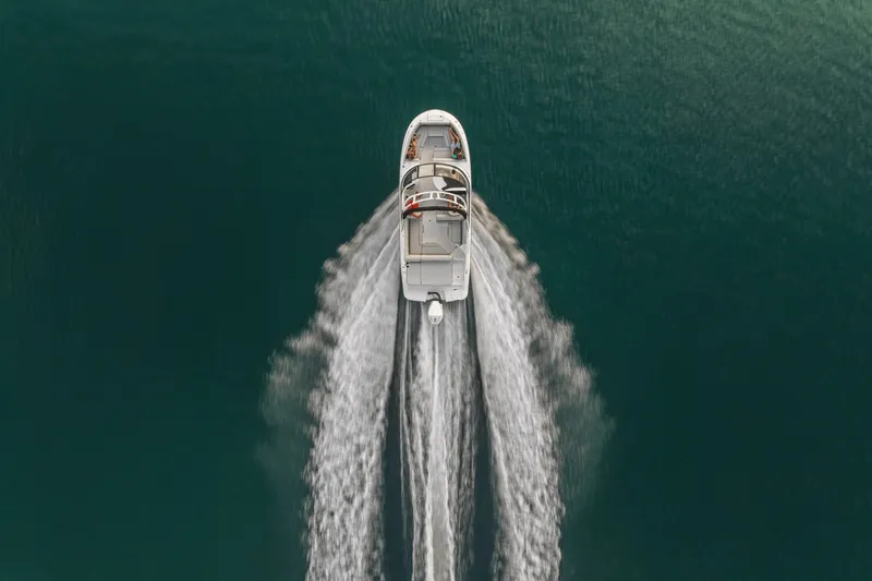 Slide: The Image of Aerial view of a Sea Ray SDX 250 Outboard boat cruising on calm water. - 44